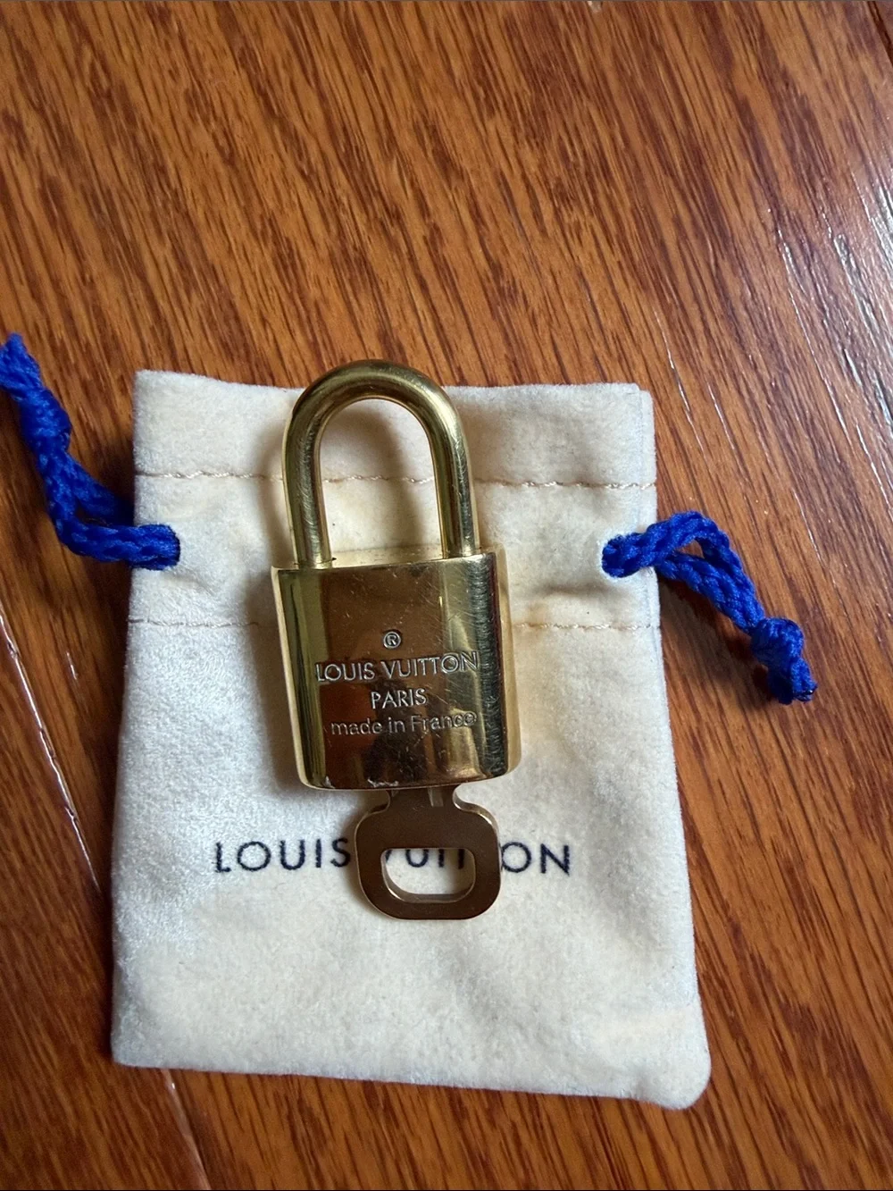 Louis Vuitton lock and Key with Cream Pouch number 324